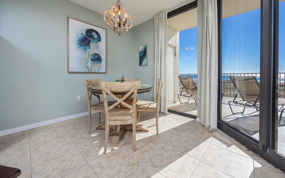 Enjoy a charming dining area for four with a view of the beachfront, perfect for meals and relaxation