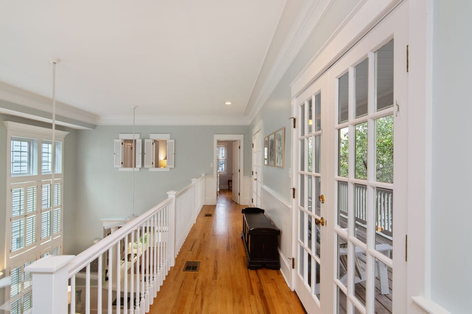 HALLWAY CONNECTING TWO BEDROOMS UP WITH FRENCH DOORS OPENING ONT