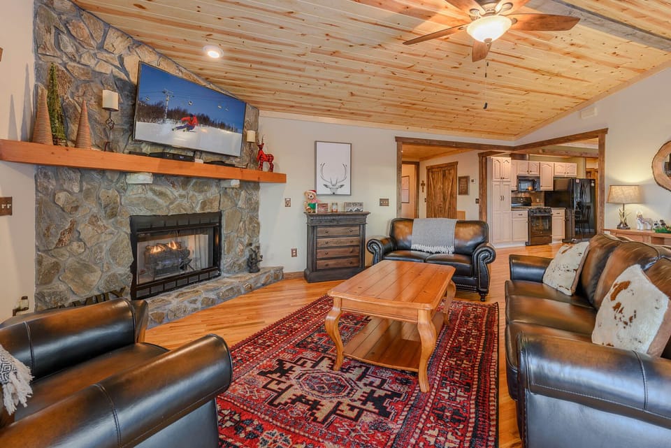 Living Room with Hardwood Floors and Stone Gas Fireplace
