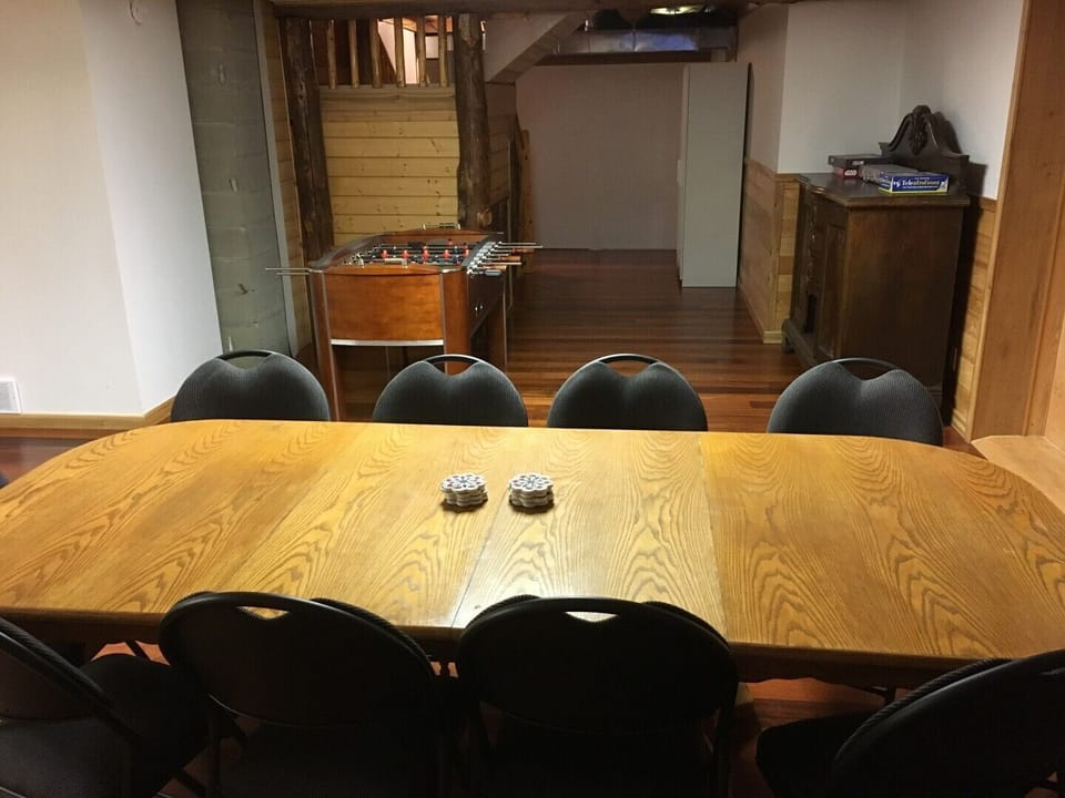 Seat 10 at the basement games room table with a good view of the TV (left of picture).