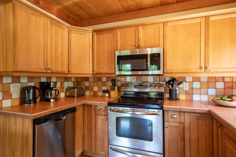 Kettle, coffee maker, toaster, blender, pots and pans, frying pans, plates,