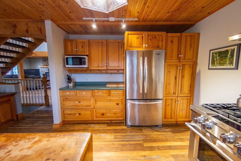 Kitchen with stainless steel refrigerator freezer and microwave