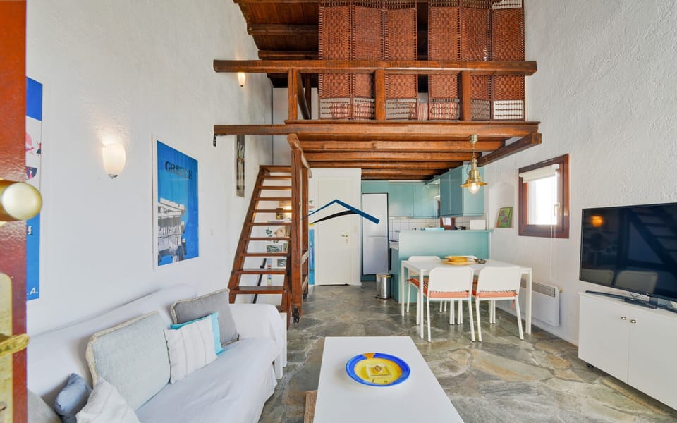 The living room, dining area, stairs leading up to the loft with the 3rd bedroom