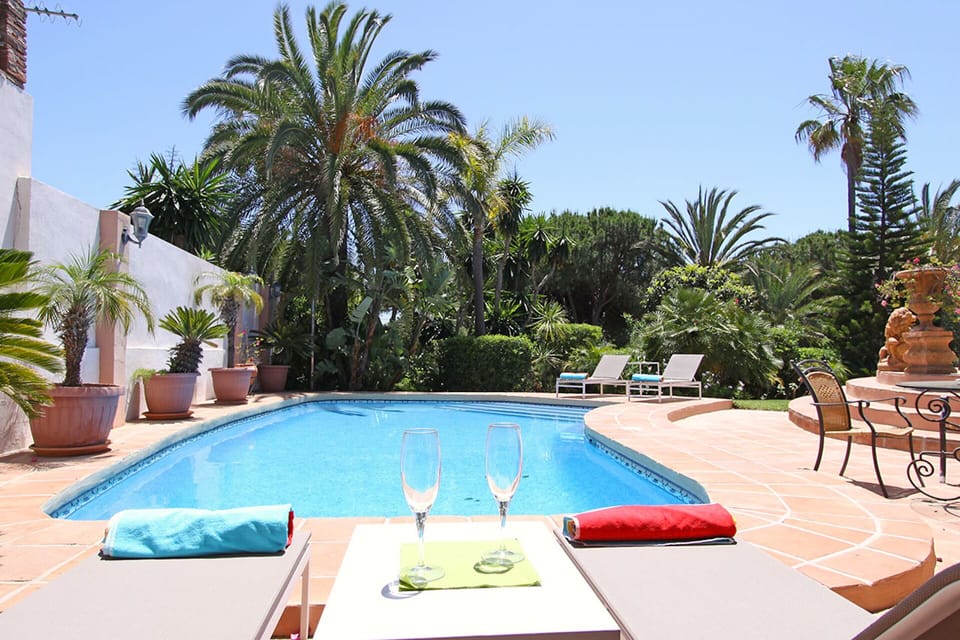Large pool area with both shaded and sunny lounge areas