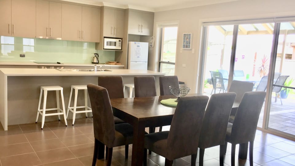 Kitchen, dining area leads to outdoor, undercover pergola and BBQ.