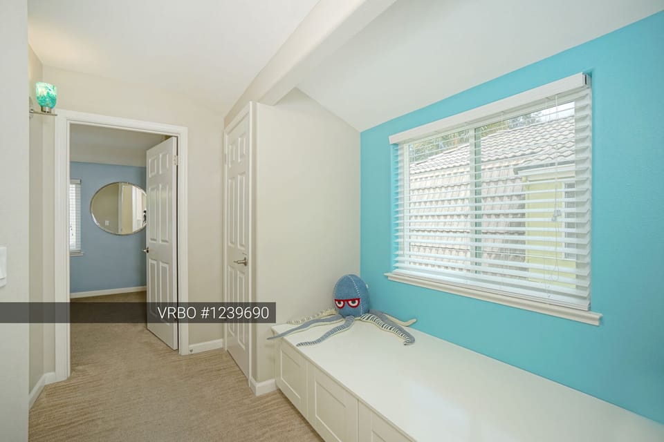 Relaxing hallway window seat.  Extra blankets and pillows in the cabinets.