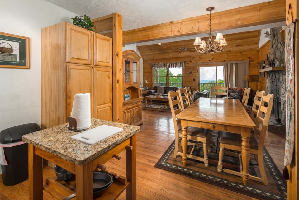 Open-concept kitchen and dining area with granite countertops and seating for family meals
