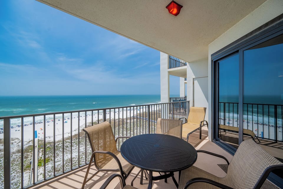 Balcony seating offers a panoramic view of the beach and turquoise gulf waters, perfect for relaxation and enjoyment