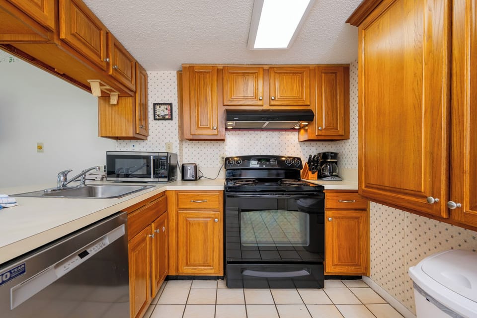 Craft delicious meals in your inviting kitchen, surrounded by charming wood cabinetry and essential appliances