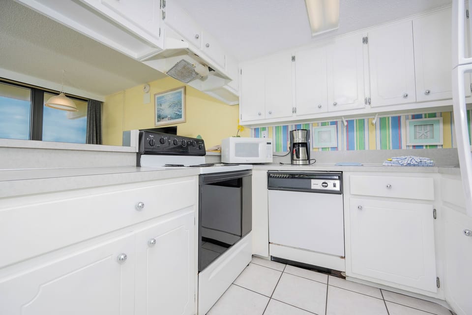 This kitchen features modern appliances and a bright atmosphere, perfect for preparing meals with a view
