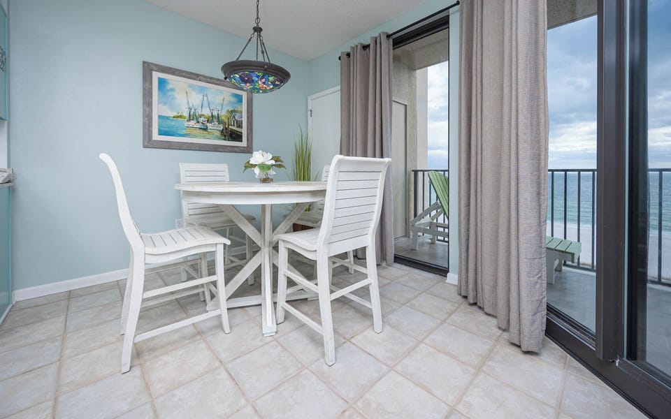 Dine at the round table while enjoying the refreshing breeze from the open sliding doors