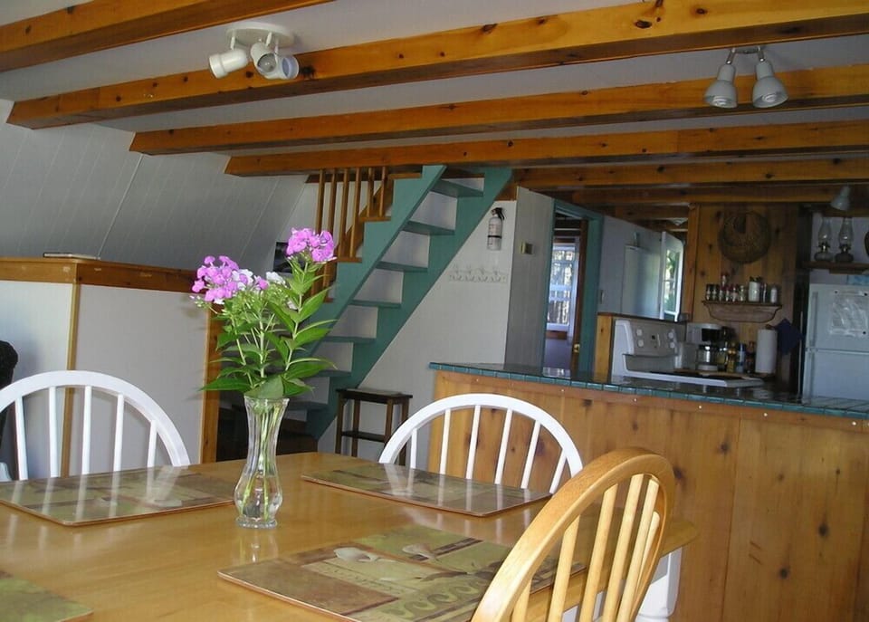 Dining area looking towards main floor bedroom and stairs to loft