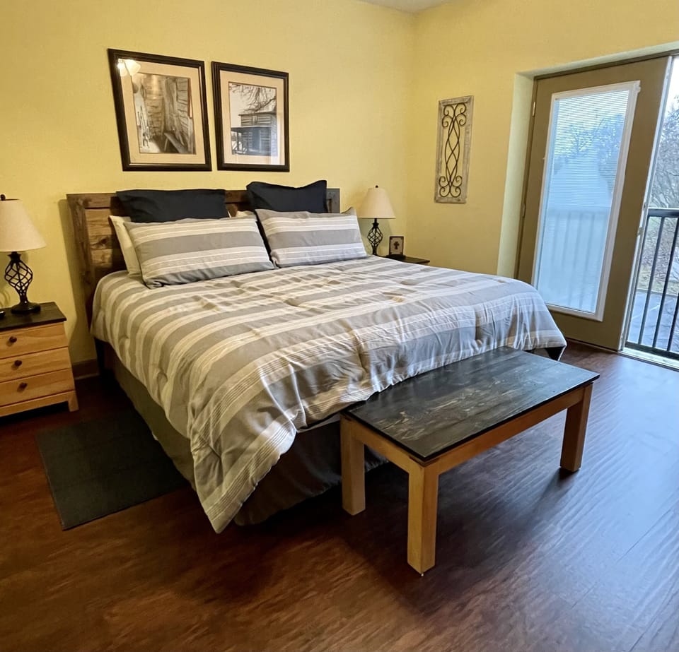 The spacious master bedroom with a king bed and Juliet balcony 