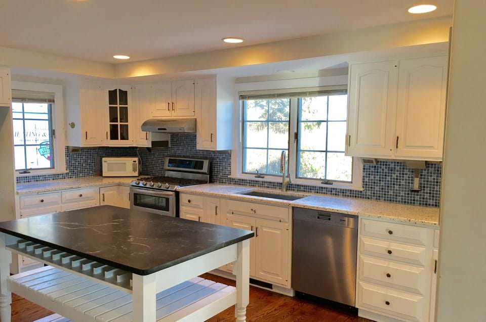 Coastal kitchen w/Miele dishwasher & KitchenAid gas stove.  Soapstone island.