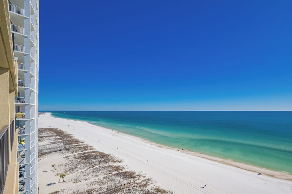 Tranquil, endless blue stretches across the coast as you savor peaceful moments from your balcony
