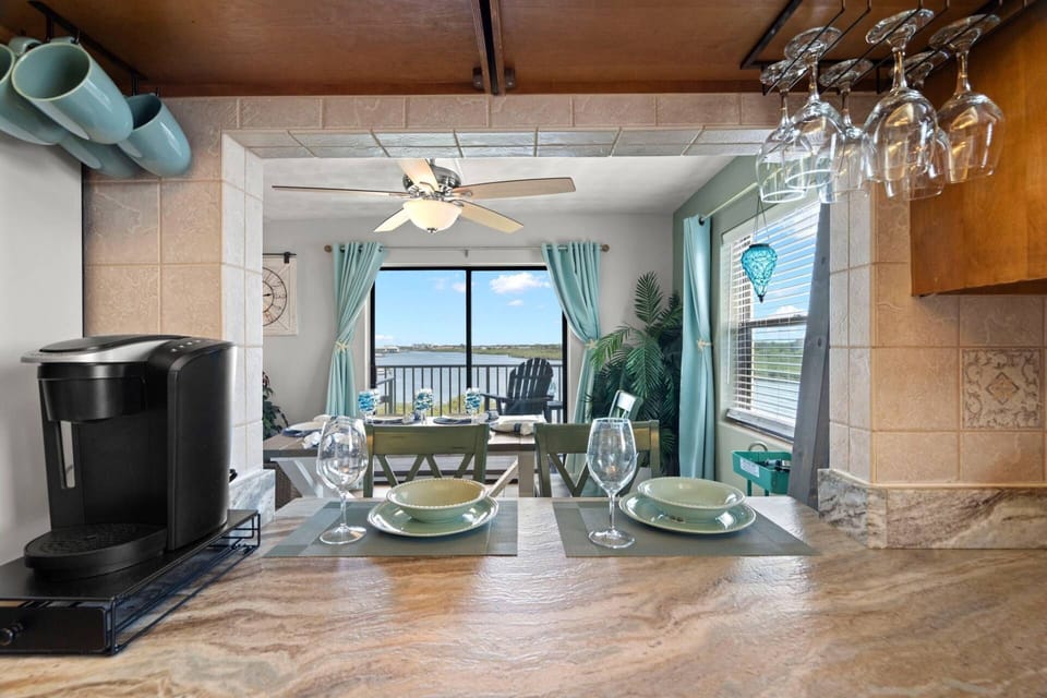 Fully Equipped Kitchen with Pass Through Window to Dining Area