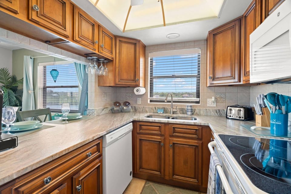 Fully Equipped Kitchen with Pass Through Window to Dining Area