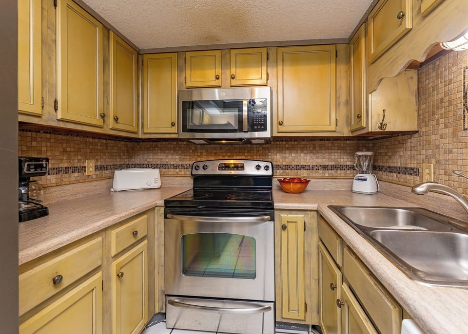Enjoy creating delicious meals in this charming kitchen, adorned with inviting decor and ample prep space