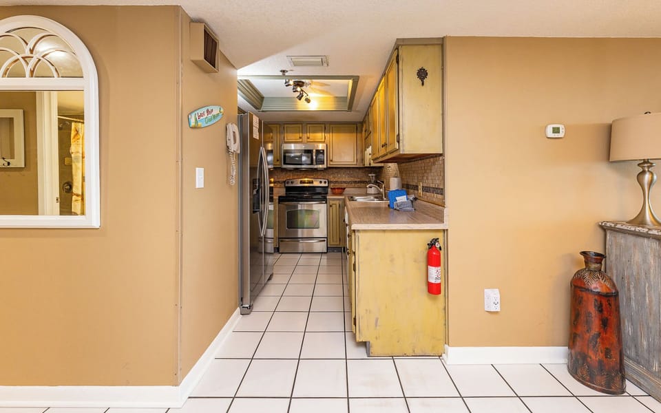 Whip up family-favorite meals in this cozy kitchen, complete with white appliances and stylish countertops