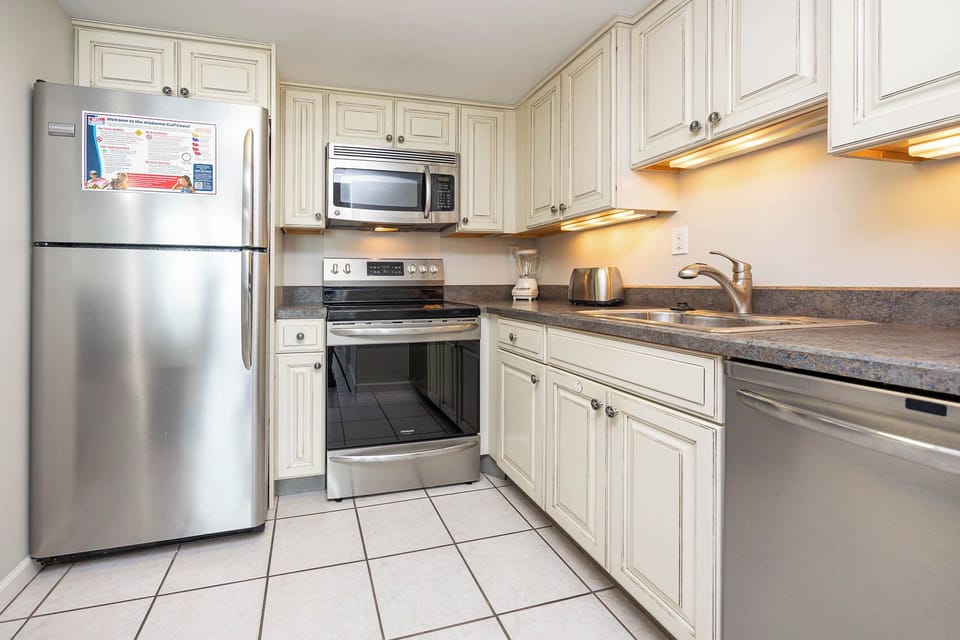 This kitchen features stainless appliances, granite countertops, and ample cabinetry for a delightful cooking experience