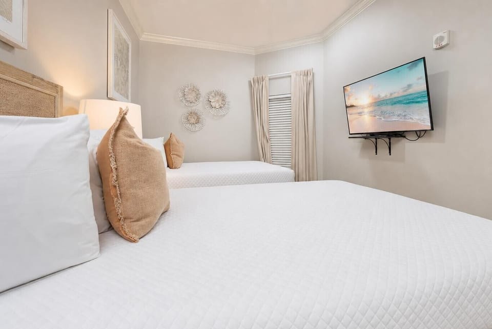 Unwind in the soft queen beds in the guest suite, enjoying favorite shows while soaking in the beach vibe