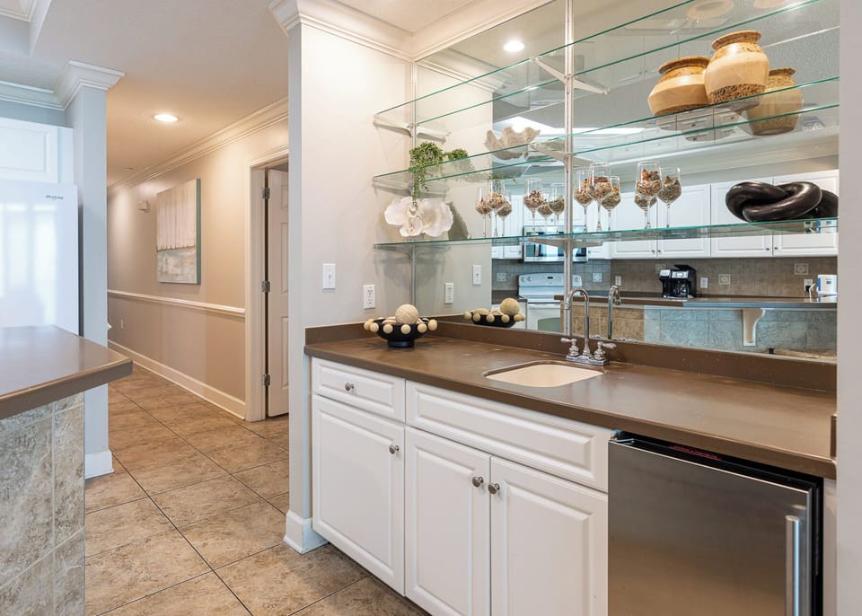 Discover the inviting wet bar, perfect for mixing drinks as you unwind and enjoy quality family time together