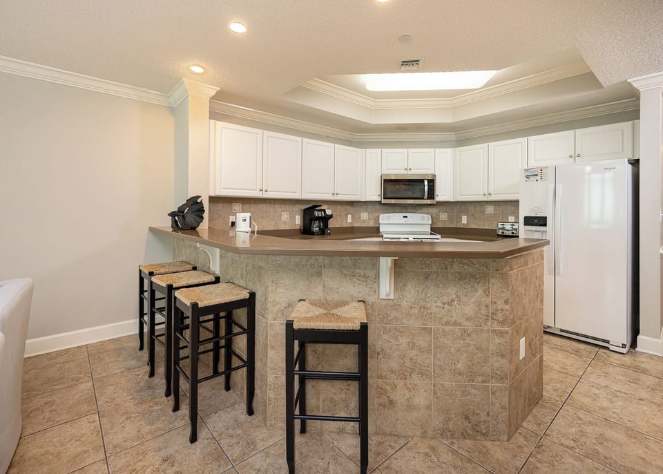 Gather around the sleek counter, sipping coffee and sharing laughs while enjoying the inviting kitchen vibe