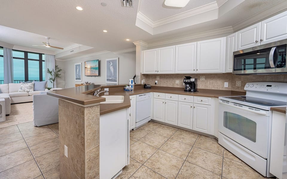Immerse yourself in family fun while preparing snacks in the inviting kitchen, with beach views nearby