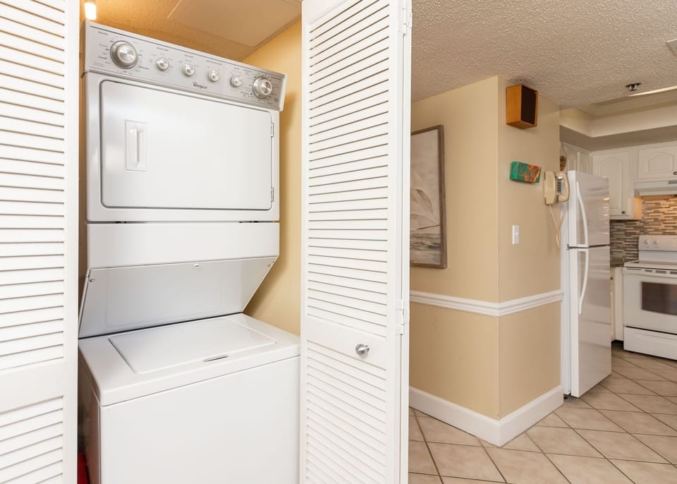 This laundry area features a stacked washer and dryer, providing convenience for your vacation needs