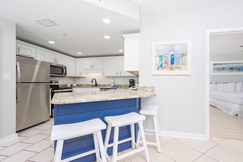 Gather around the sleek granite counter with seating, perfect for casual meals and morning coffee