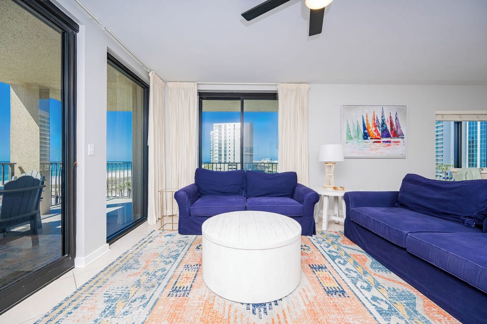 Relax on the plush sofa with queen sleeper while enjoying the vibrant decor and beach views from the large windows