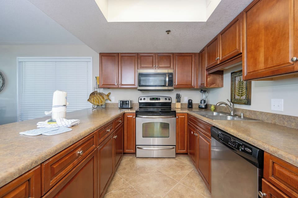 Cook your favorite dishes in this inviting kitchen, where warm wood tones create a welcoming vibe for family gatherings