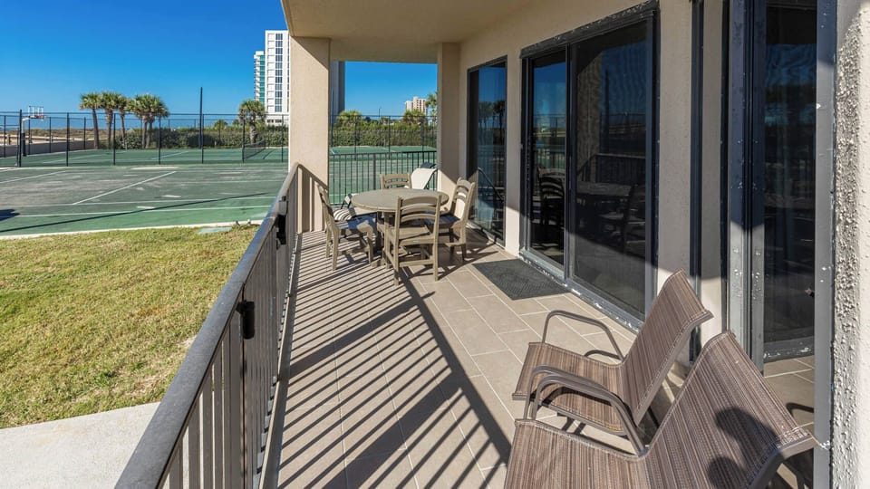 Patio area with comfortable seating and enjoy views of the nearby tennis courts and grassy area