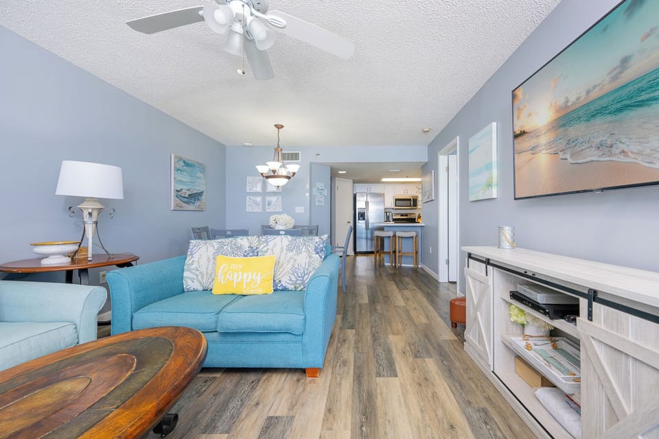 Stretch out on the living room sofa and enjoy family movie nights with coastal art all around you