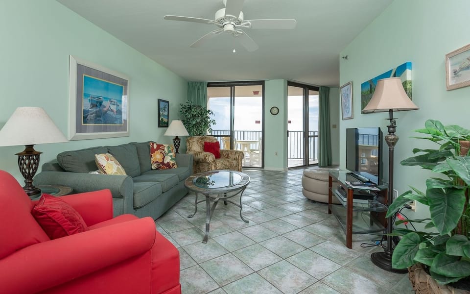 Relax in this inviting living area, featuring a sofa with queen sleeper and beachfront balcony view