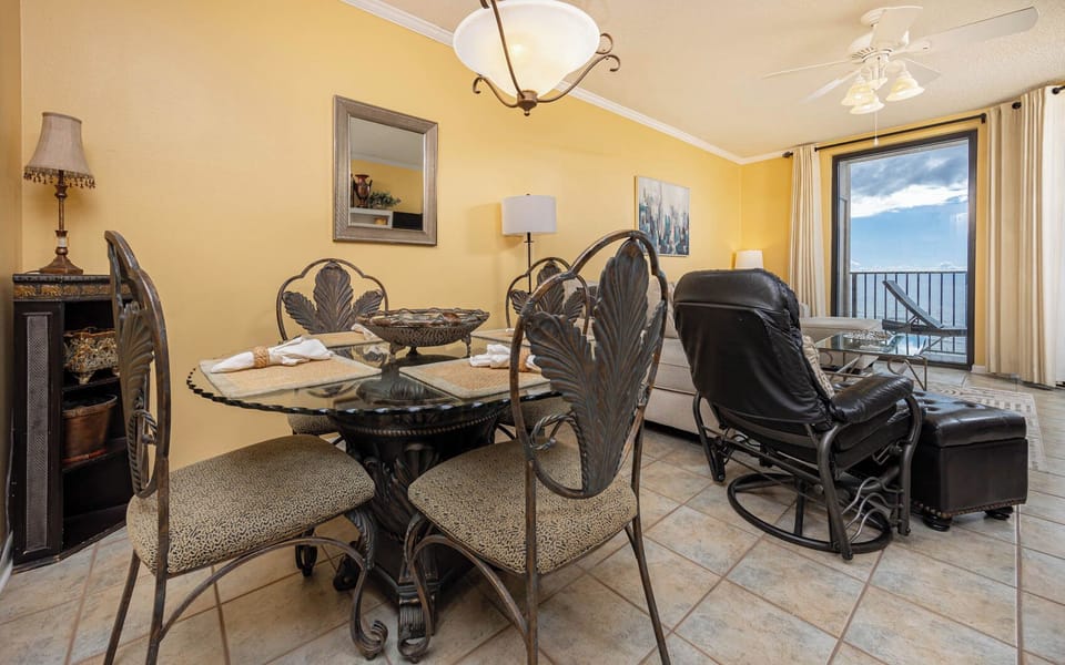 Dine at the elegant glass table while enjoying the inviting atmosphere and views from the spacious living area