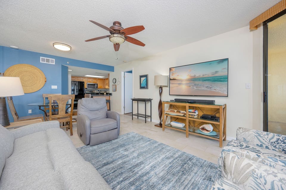 Soft breeze from the ceiling fan stirs as you gather with family in the cozy living room nook