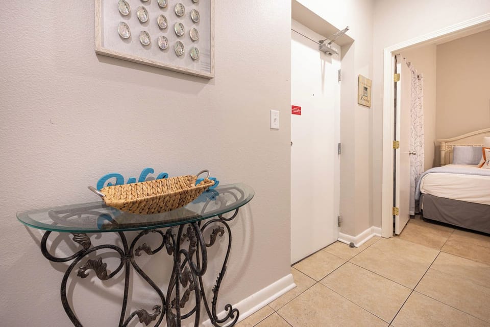 Step into a welcoming entryway featuring a stylish console table and easy access to the cozy bedroom beyond