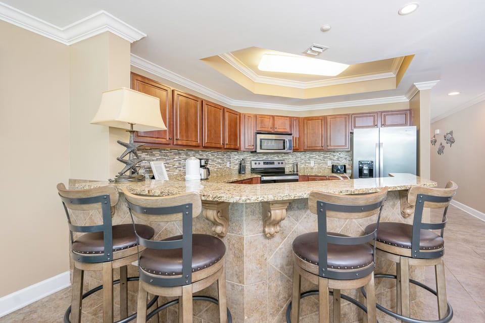 Gather around the curved bar for casual conversations, sipping drinks while enjoying the warm beach vibe