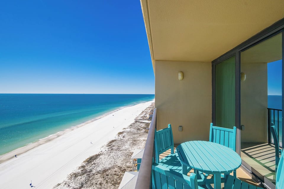 Your balcony invites you to savor the endless blue horizon and lively beach below