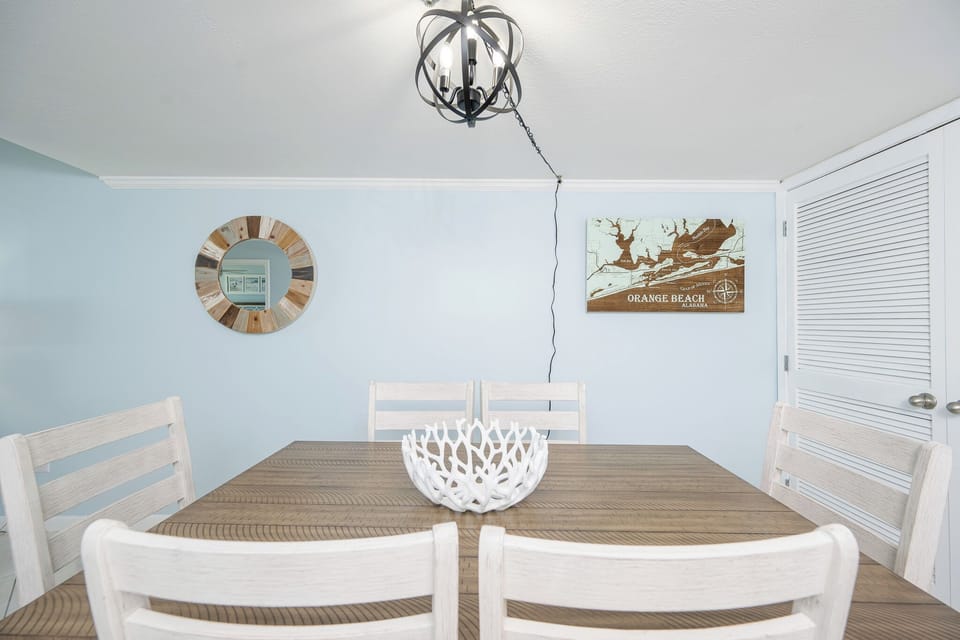 Gather around the charming dining table, enjoying heartfelt conversations in the coastal vibe of your vacation home