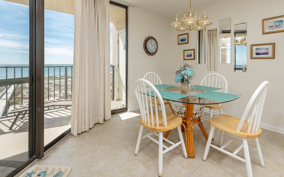 Dine at the glass table while enjoying views through the large windows that invite natural light into the space