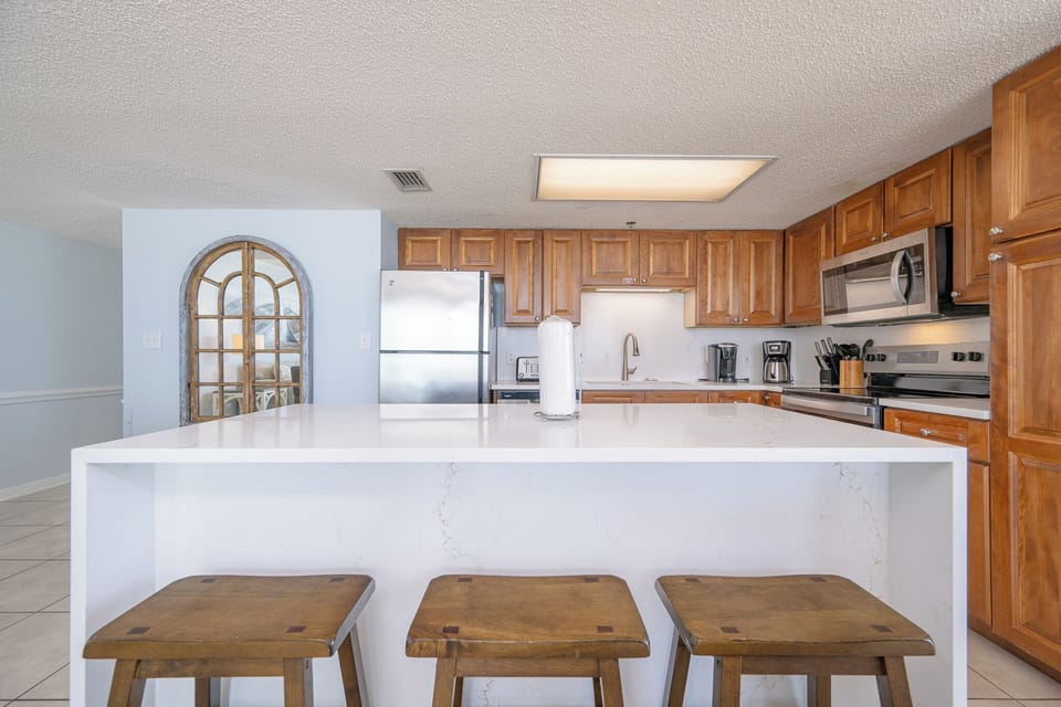 Pull up a wooden stool at the breakfast bar to sip morning coffee and chat in the bright kitchen nook