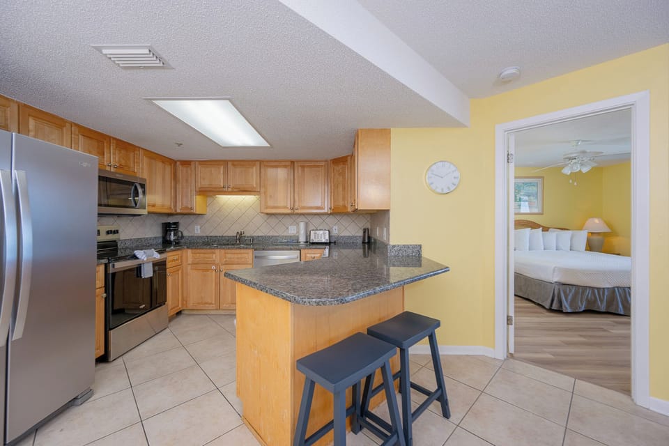 Warm light fills the kitchen where you gather around the breakfast bar before heading to the queen guest suite