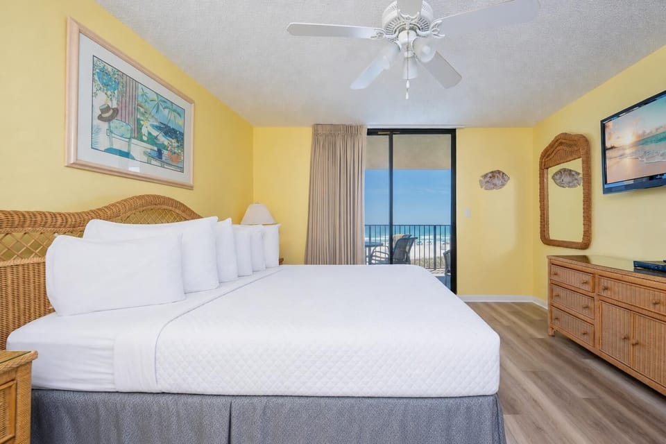 Sink into soft linens in this king master suite while the beach view unfolds beyond your balcony doors