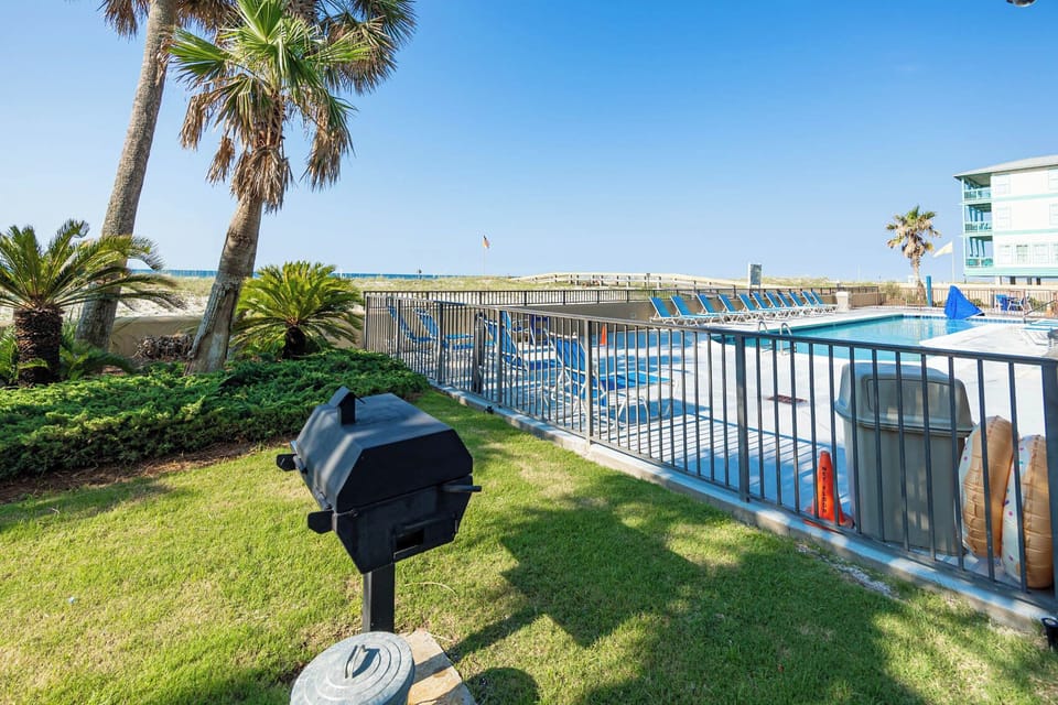 Relax by the pool with a grill nearby and a stunning beach view just steps away for a perfect getaway experience