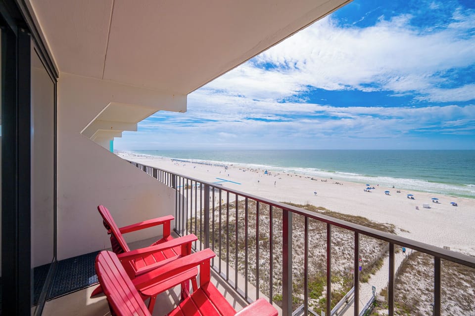Sink into vibrant chairs on your balcony, savoring coastline views and the gentle sound of waves rolling ashore
