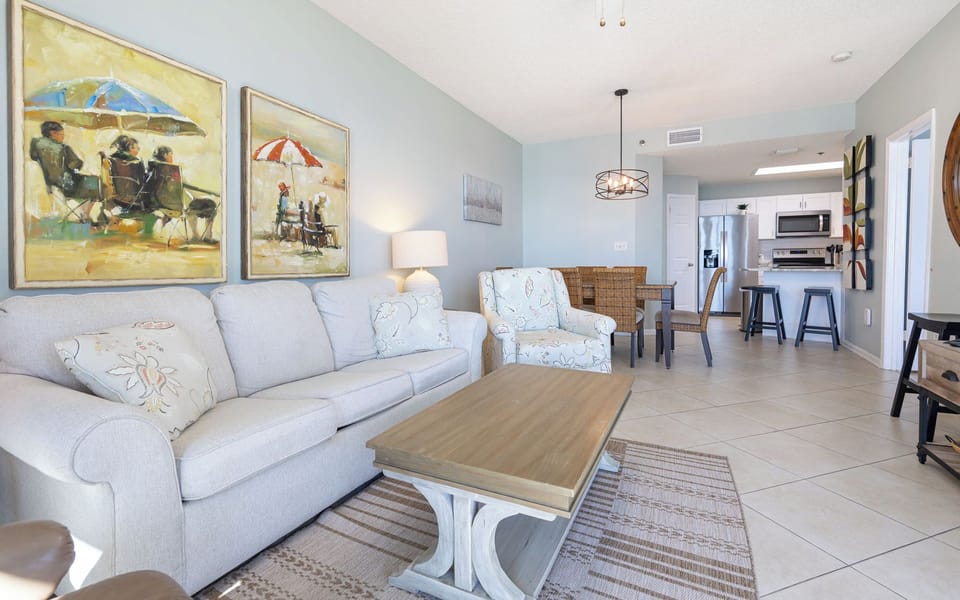 Relax on the comfortable sofa with queen sleeper, surrounded by beach art and a welcoming dining area