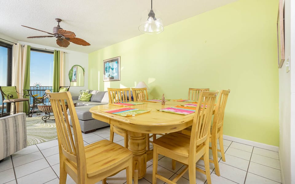 Gather around the wooden dining table, surrounded by vibrant decor and a cozy living area with inviting seating