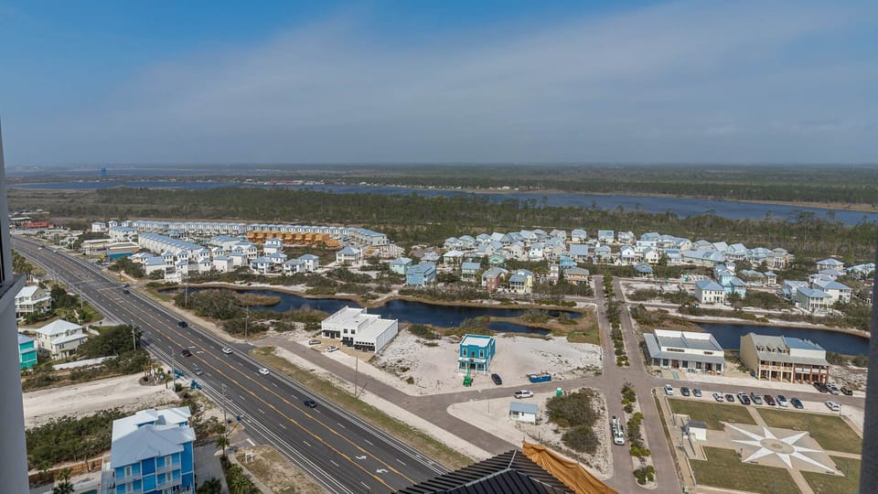 This view showcases a vibrant landscape with charming homes and a serene waterway, perfect for a relaxing getaway